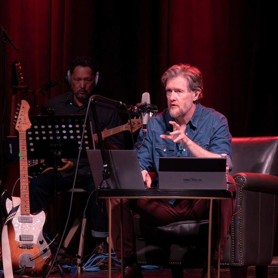 Lindsay seated with band
